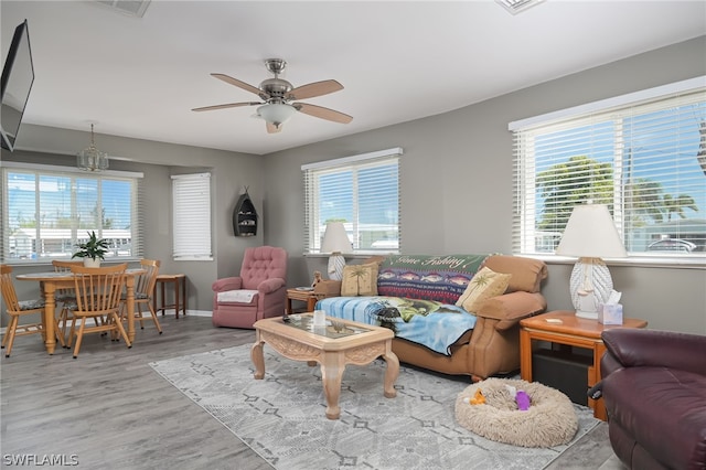 living room with light hardwood / wood-style flooring, a wealth of natural light, and ceiling fan