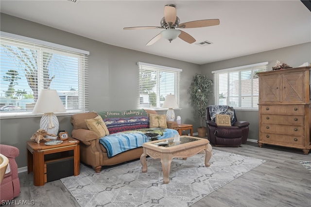 living room with ceiling fan and light wood-type flooring