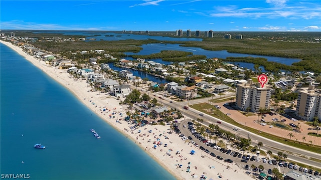 bird's eye view with a water view and a view of the beach