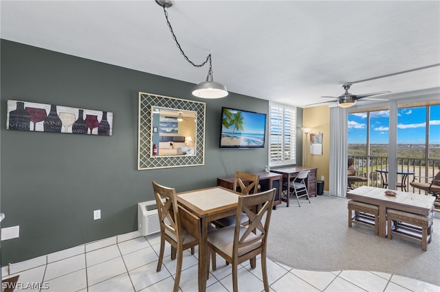 tiled dining area featuring ceiling fan and a wall unit AC