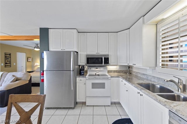 kitchen featuring white cabinets, stainless steel appliances, ceiling fan, sink, and light tile flooring