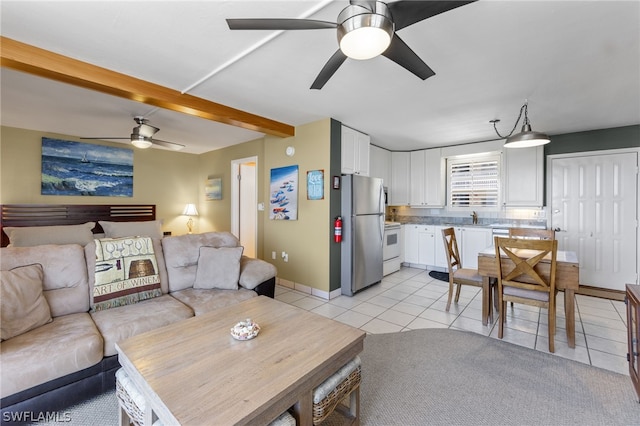 living room featuring sink, beam ceiling, ceiling fan, and light tile flooring