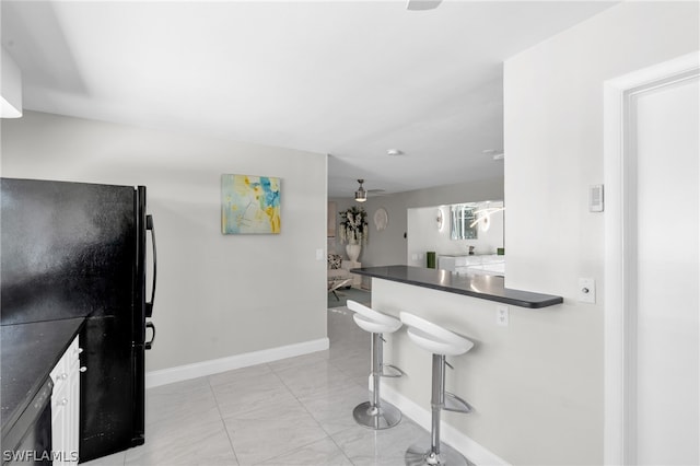 kitchen with ceiling fan and black appliances