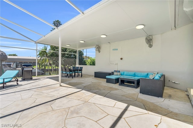 view of patio with an outdoor living space and glass enclosure