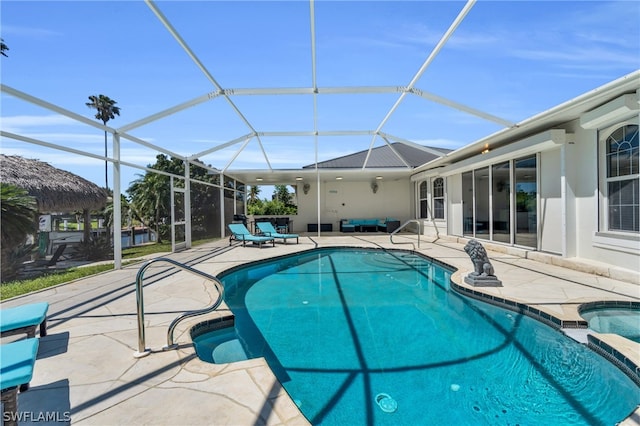 view of pool featuring a patio area and glass enclosure