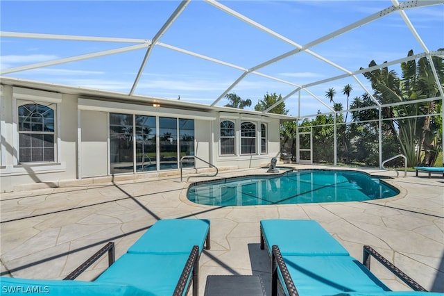 view of pool with a patio and a lanai