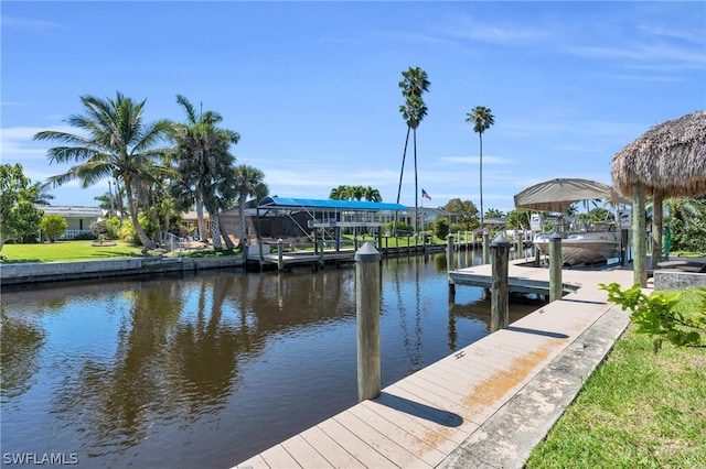 view of dock featuring a water view and a lawn