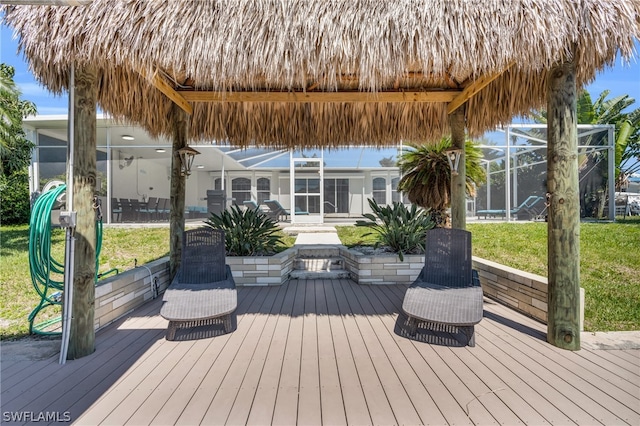 wooden deck featuring a yard and glass enclosure