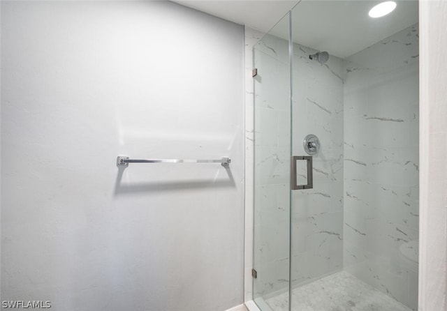 bathroom with toilet and a shower with shower door