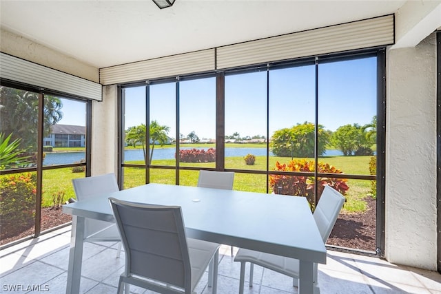 sunroom / solarium featuring a water view