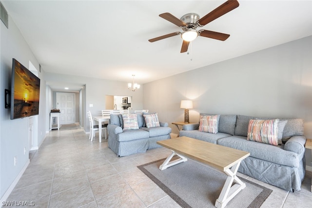 living room featuring light tile floors and ceiling fan with notable chandelier