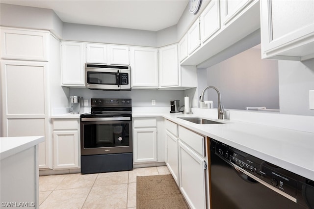 kitchen featuring range with electric cooktop, light tile floors, dishwasher, sink, and white cabinetry