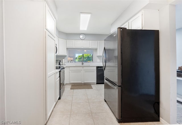 kitchen featuring dishwasher, stainless steel refrigerator, white cabinetry, and electric range