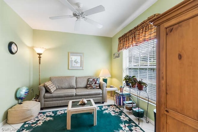 living room with ceiling fan and tile patterned floors