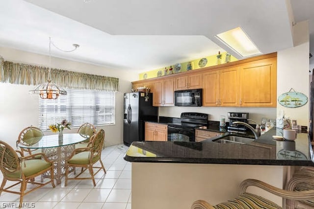 kitchen with an inviting chandelier, kitchen peninsula, light tile patterned flooring, black appliances, and sink