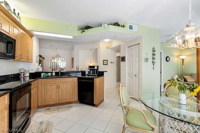 kitchen with a notable chandelier, sink, pendant lighting, and black appliances