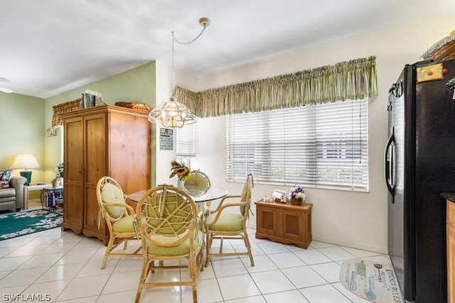 dining area featuring light tile patterned floors and a chandelier