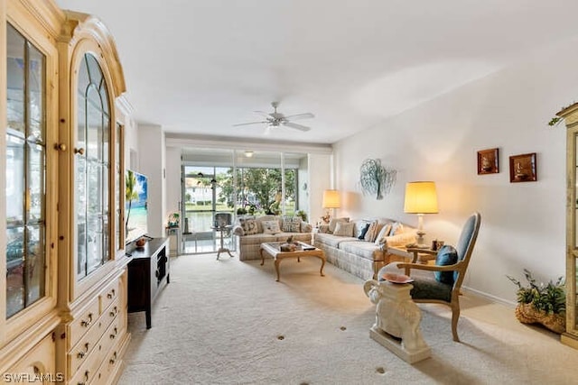 living room with ceiling fan and light colored carpet