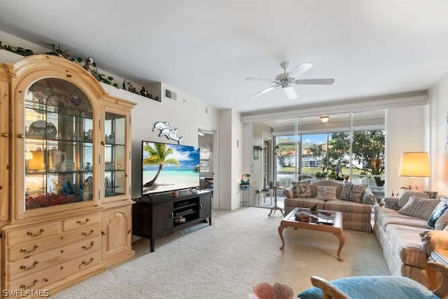 carpeted living room featuring ceiling fan