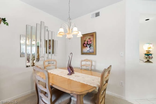 dining area with light carpet and an inviting chandelier