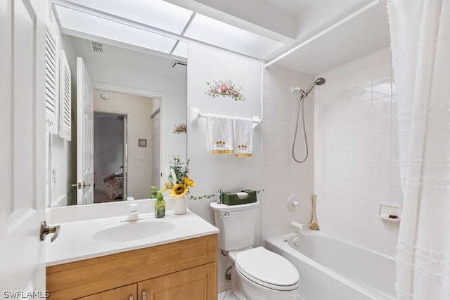 full bathroom with toilet, vanity, and shower / tub combo