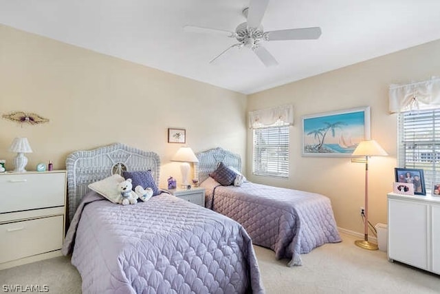 bedroom with ceiling fan and light colored carpet