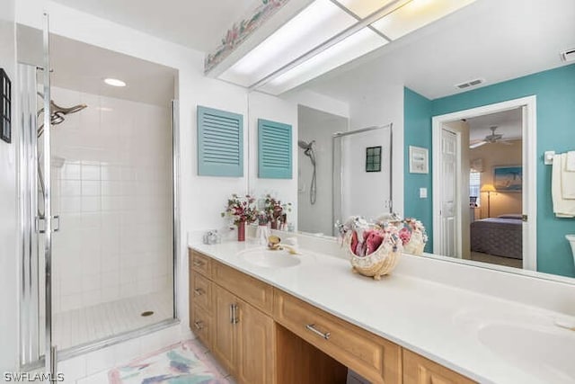 bathroom featuring ceiling fan, tile patterned flooring, walk in shower, and vanity