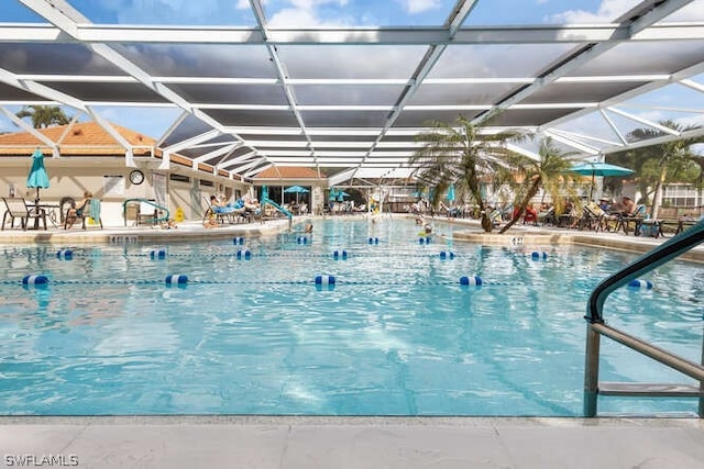 view of swimming pool featuring a lanai