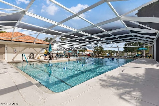 view of pool with a patio area and a lanai