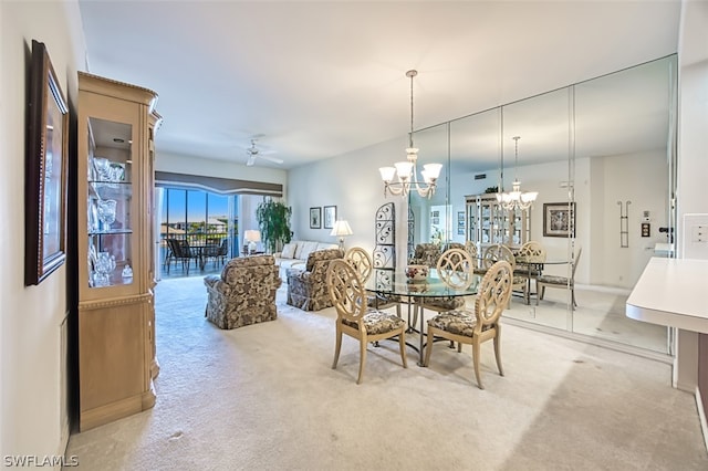 carpeted dining space with ceiling fan with notable chandelier