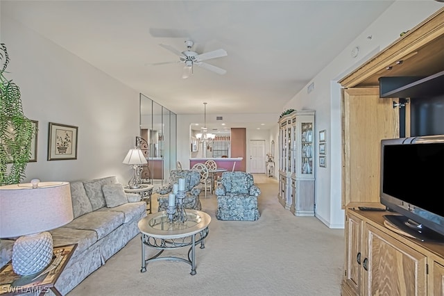 living room with light carpet and ceiling fan with notable chandelier