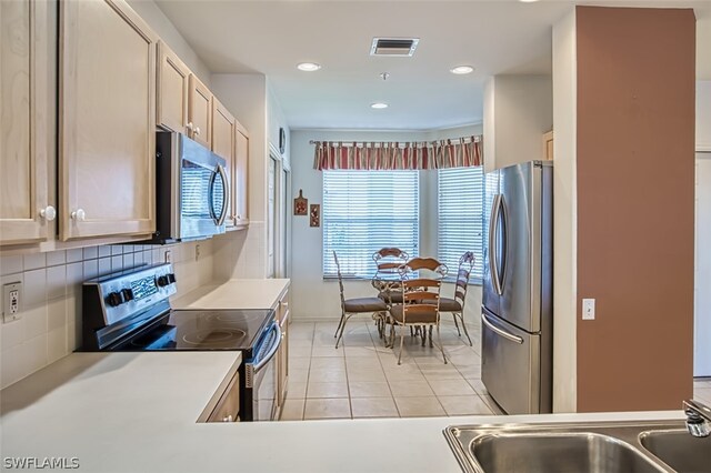 kitchen with decorative backsplash, sink, a healthy amount of sunlight, and appliances with stainless steel finishes