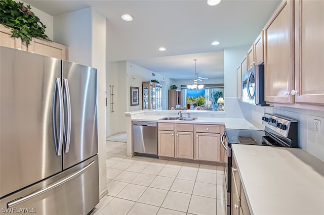 kitchen with sink, hanging light fixtures, stainless steel appliances, light brown cabinetry, and light tile patterned flooring