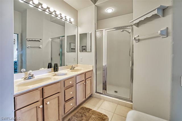 bathroom with tile patterned floors, vanity, and an enclosed shower