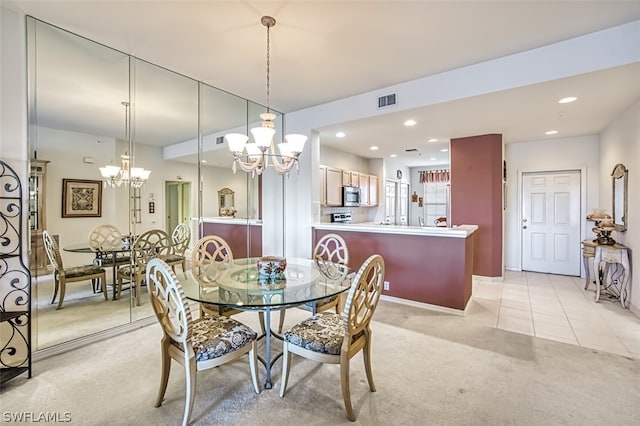 carpeted dining area with a chandelier