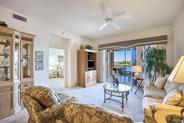 living room with light colored carpet and ceiling fan