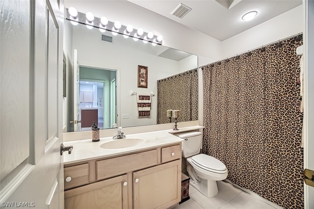 bathroom featuring tile patterned floors, curtained shower, vanity, and toilet