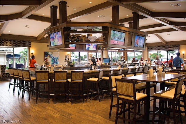 dining space featuring hardwood / wood-style flooring and beam ceiling