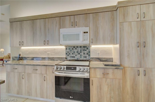 kitchen with light brown cabinets and stainless steel electric range