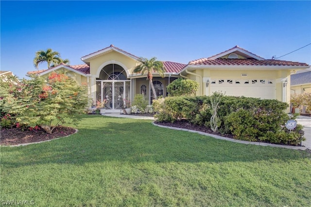 view of front of home featuring a front lawn, an attached garage, a tile roof, and stucco siding