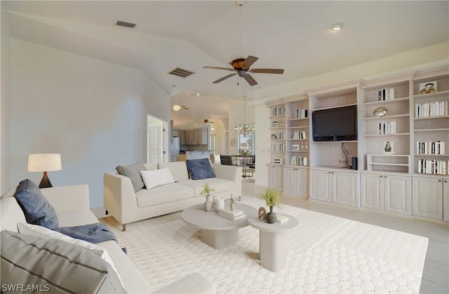 living room with ceiling fan and lofted ceiling