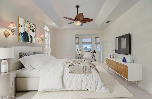 bedroom featuring a tray ceiling and ceiling fan