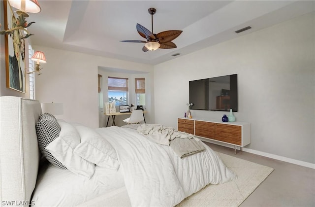 bedroom featuring a tray ceiling and ceiling fan