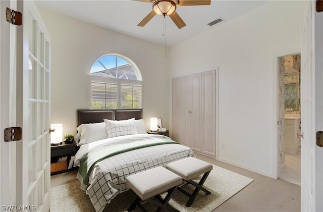 carpeted bedroom featuring ensuite bathroom and ceiling fan