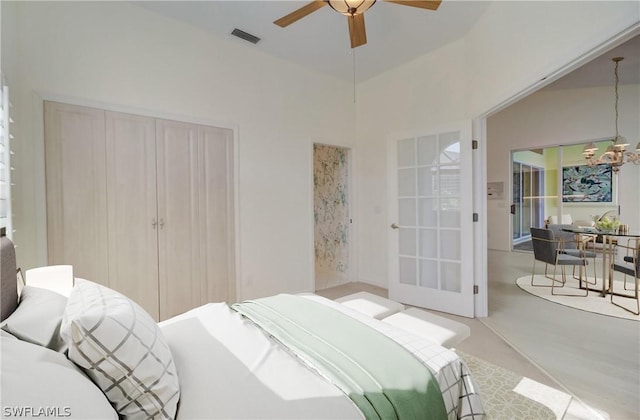 bedroom with ceiling fan with notable chandelier