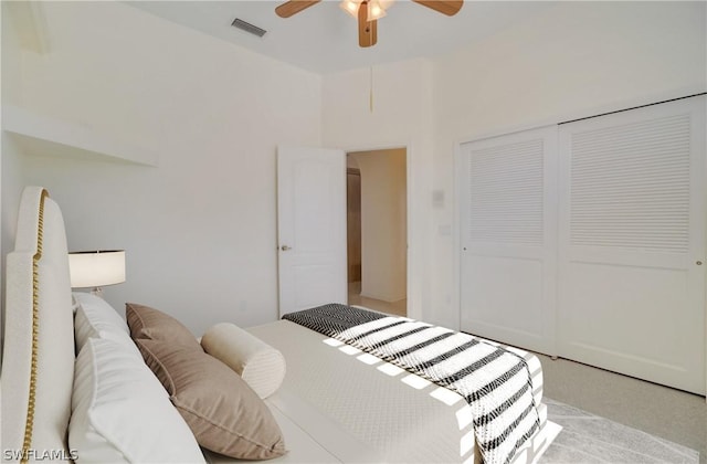 carpeted bedroom with ceiling fan and a closet