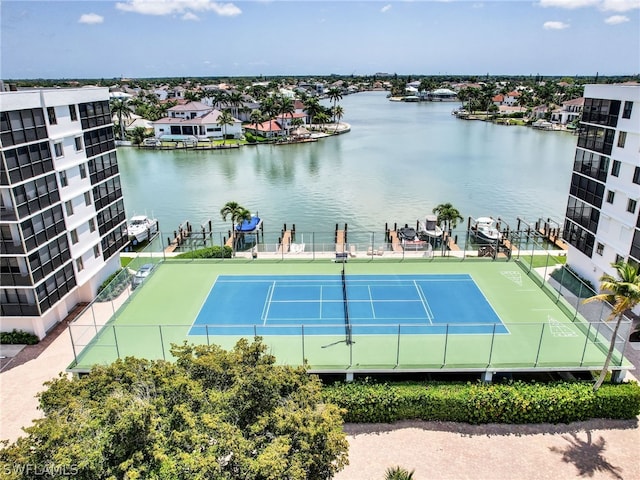 view of tennis court featuring a water view