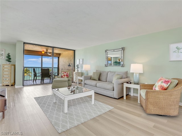 living room featuring floor to ceiling windows and light hardwood / wood-style floors