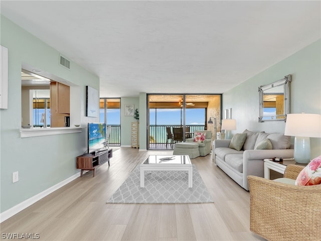 living room featuring a wealth of natural light and light hardwood / wood-style flooring