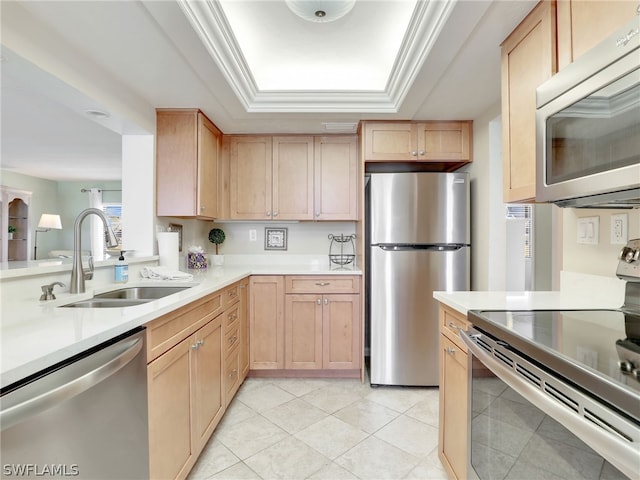 kitchen with light tile floors, stainless steel appliances, light brown cabinetry, sink, and a raised ceiling